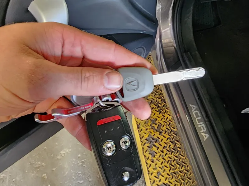 Acura flip key and fob held in hand
