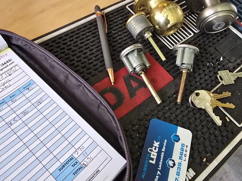 Disassembled lock cylinders with Alberta Lock business card