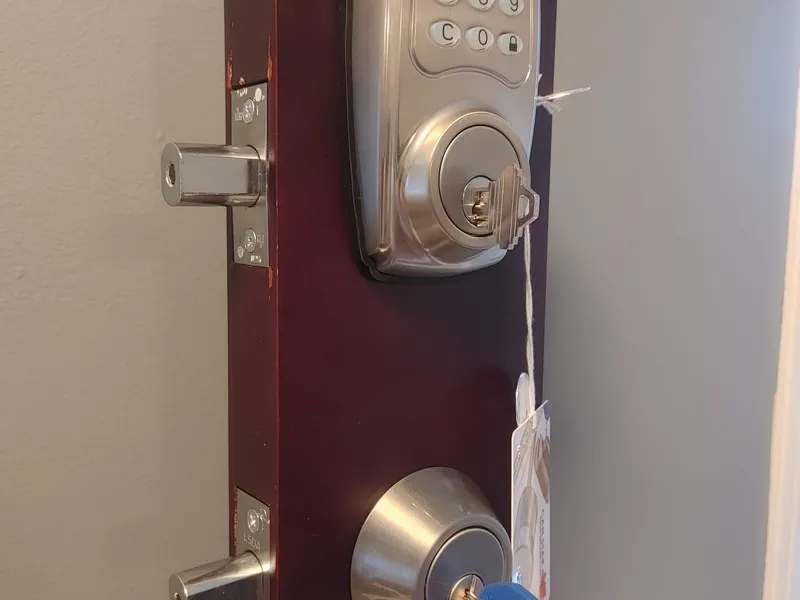 Electronic deadbolt next to a mechanical LSDA deadbolt on display