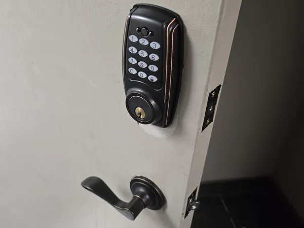 Electronic keypad deadbolt installed on a white door