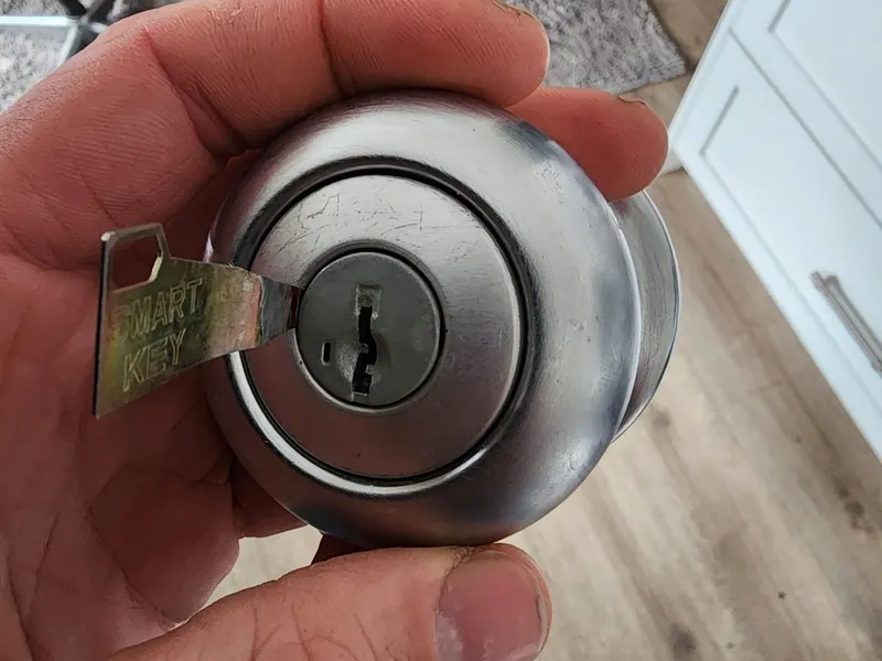 Kwikset SmartKey deadbolt being rekeyed with the manufacturer tool