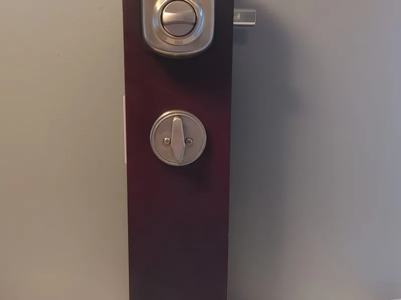 LSDA electronic deadbolt on a display stand with a business card