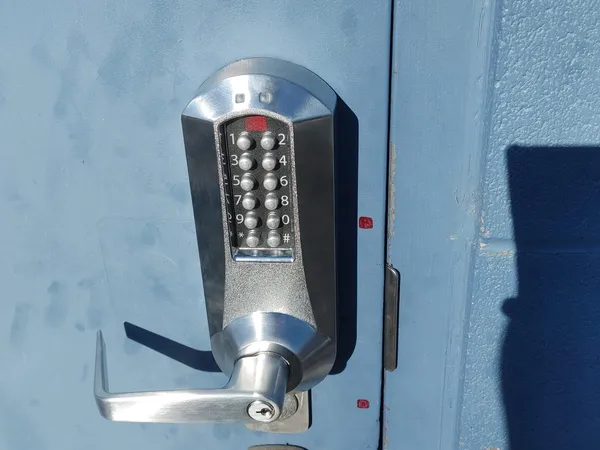 Mechanical pushbutton lever lock on a blue door