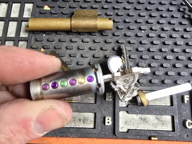 Rekey pinning a cylinder with coloured pins on a work mat