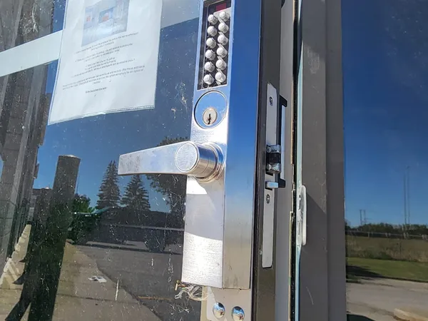 Storefront pushbutton mortise lock installed