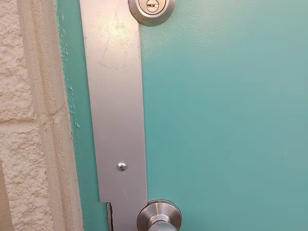 Teal door with Mul-T-Lock deadbolt and jamb reinforcement