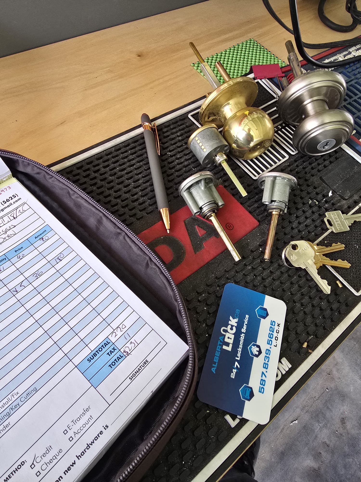 Disassembled lock cylinders with Alberta Lock business card