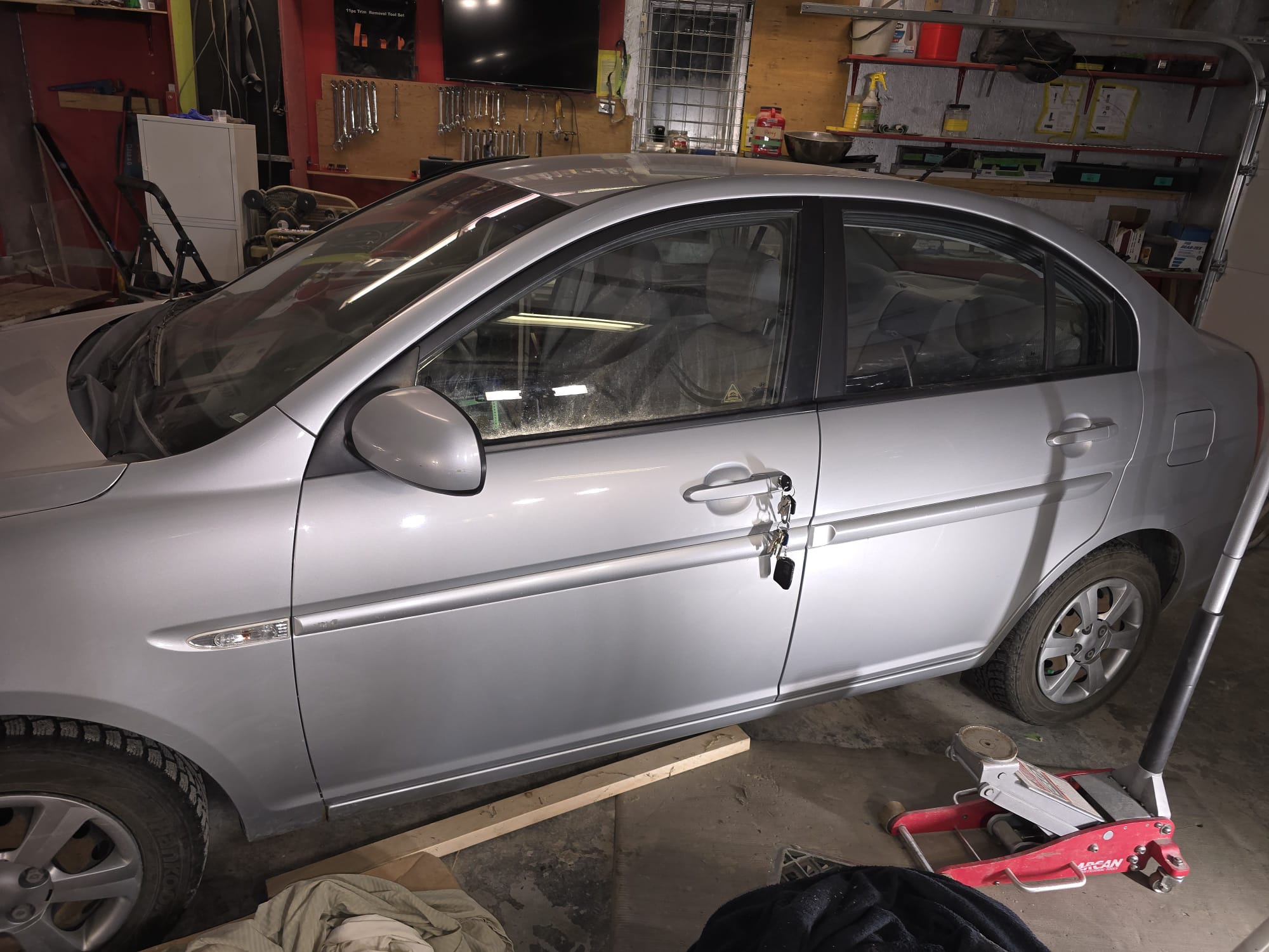 Silver Hyundai sedan in a shop bay during locksmith service