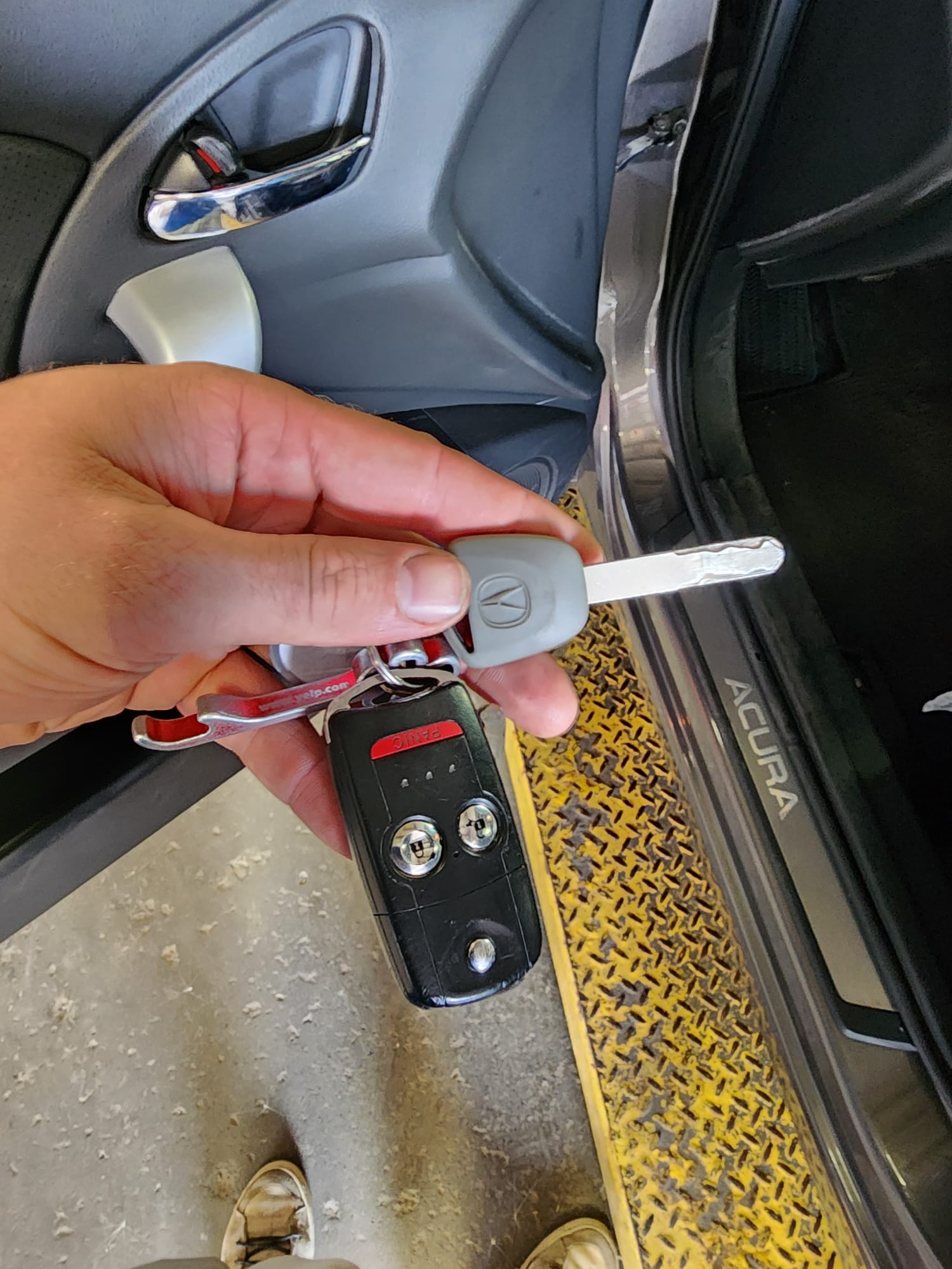 Acura flip key and fob held in hand