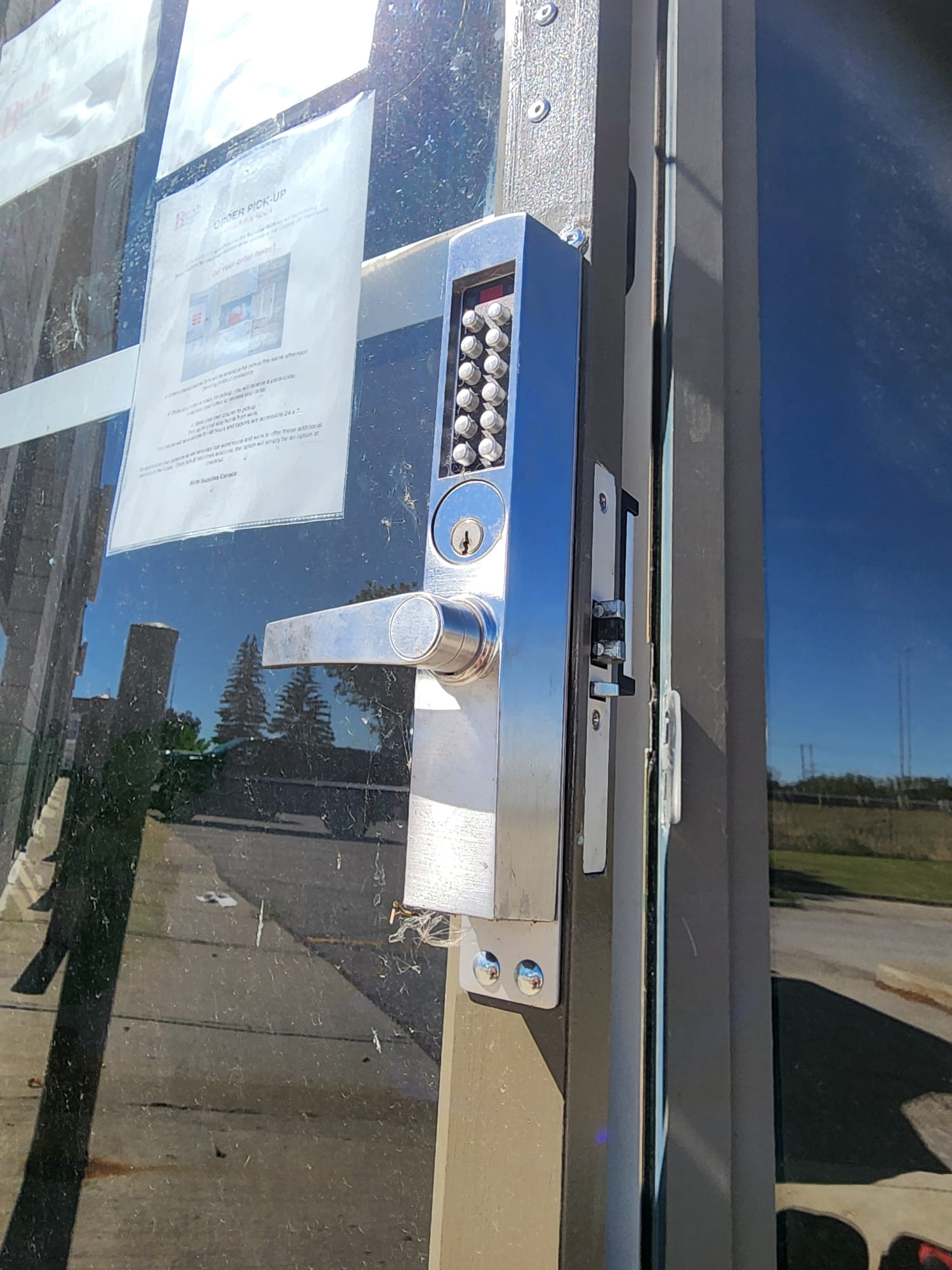 Storefront pushbutton mortise lock installed