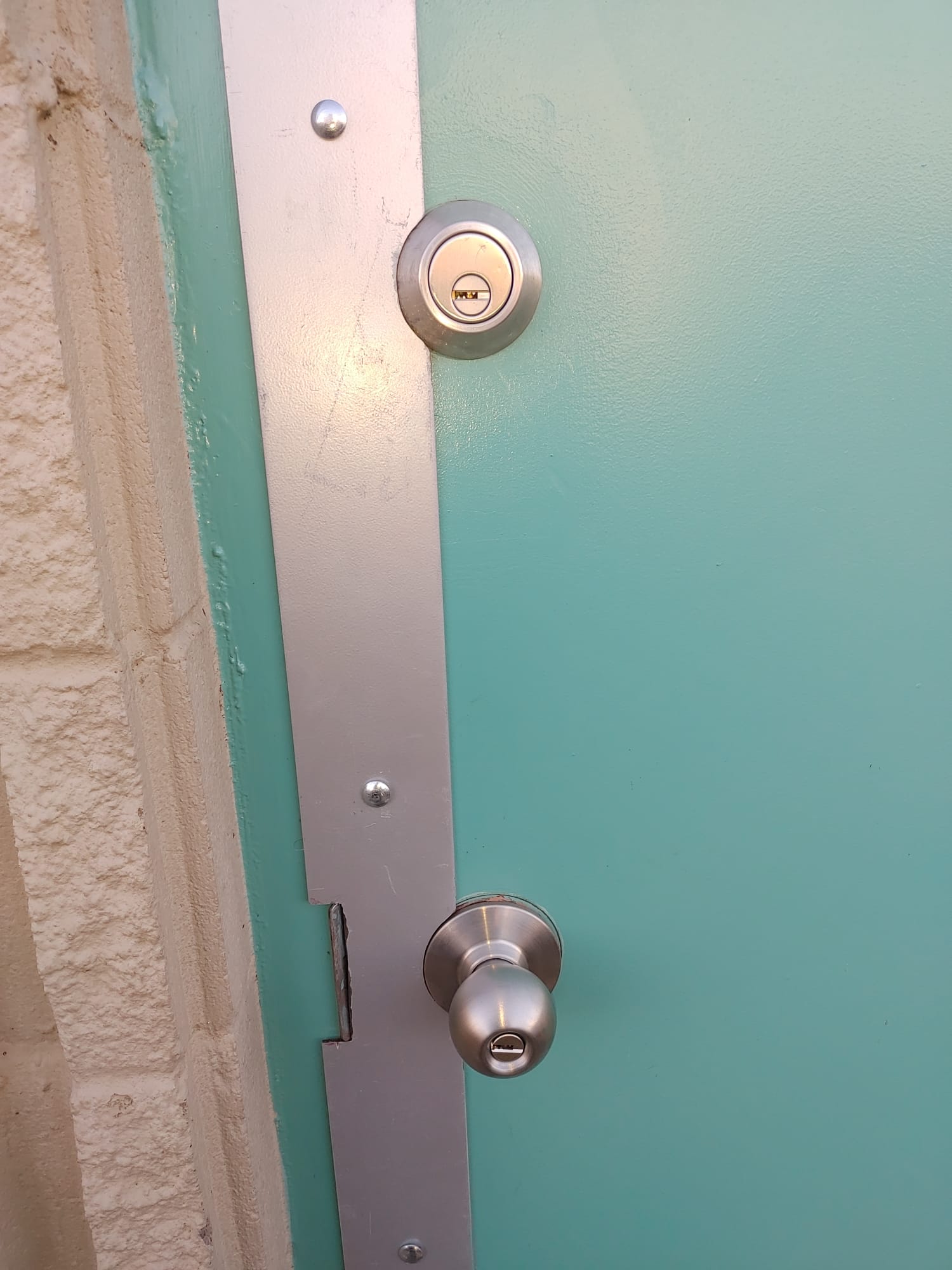 Teal door with Mul-T-Lock deadbolt and jamb reinforcement