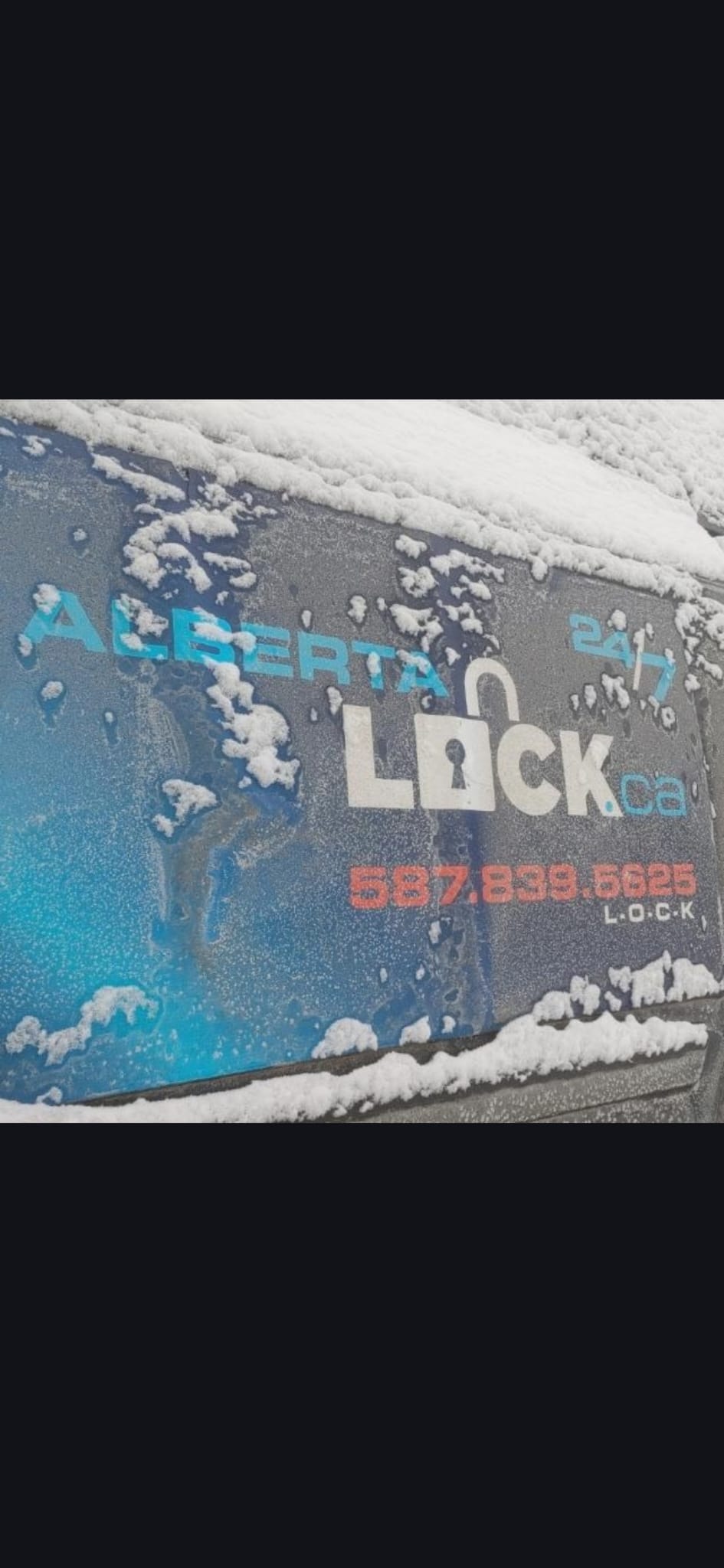 Alberta Lock service van with branding visible in winter