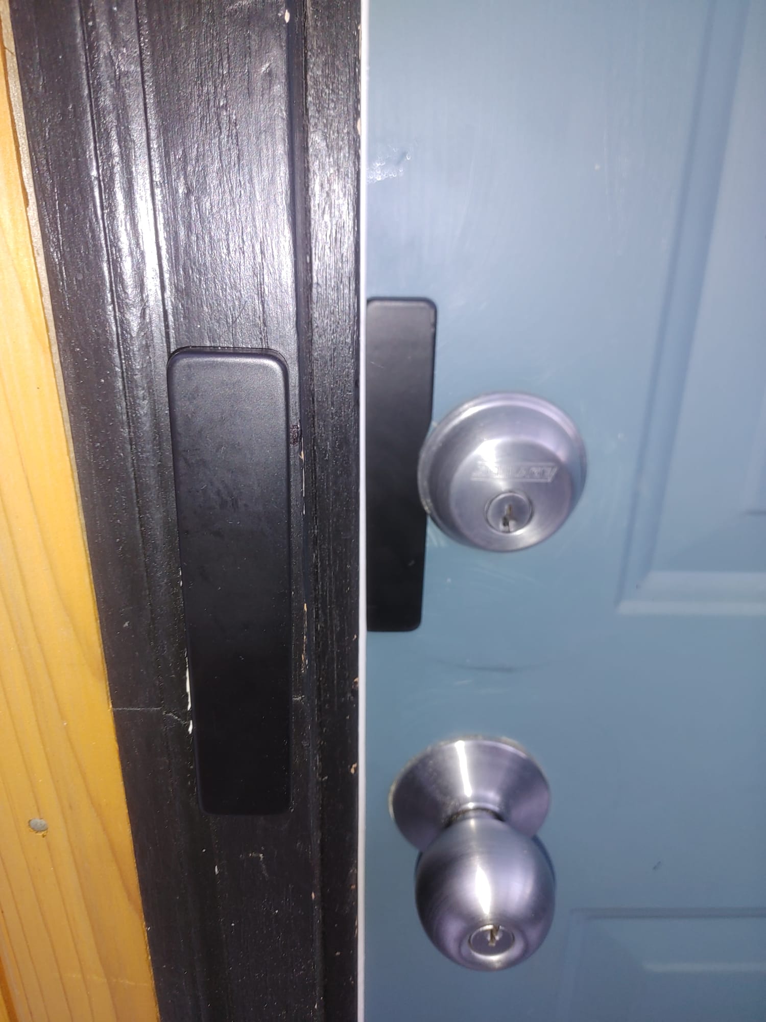 Blue door with Schlage deadbolt installed at the jamb edge
