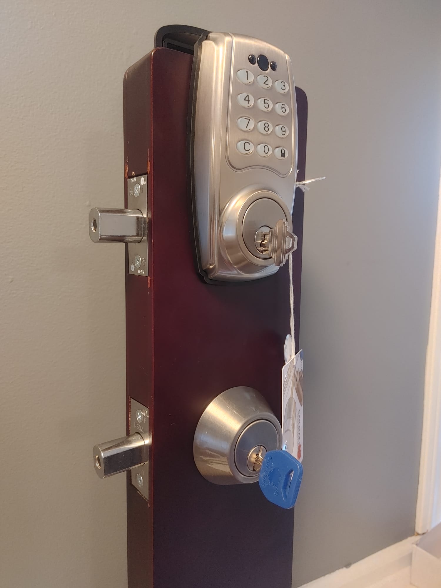 Electronic deadbolt next to a mechanical LSDA deadbolt on display