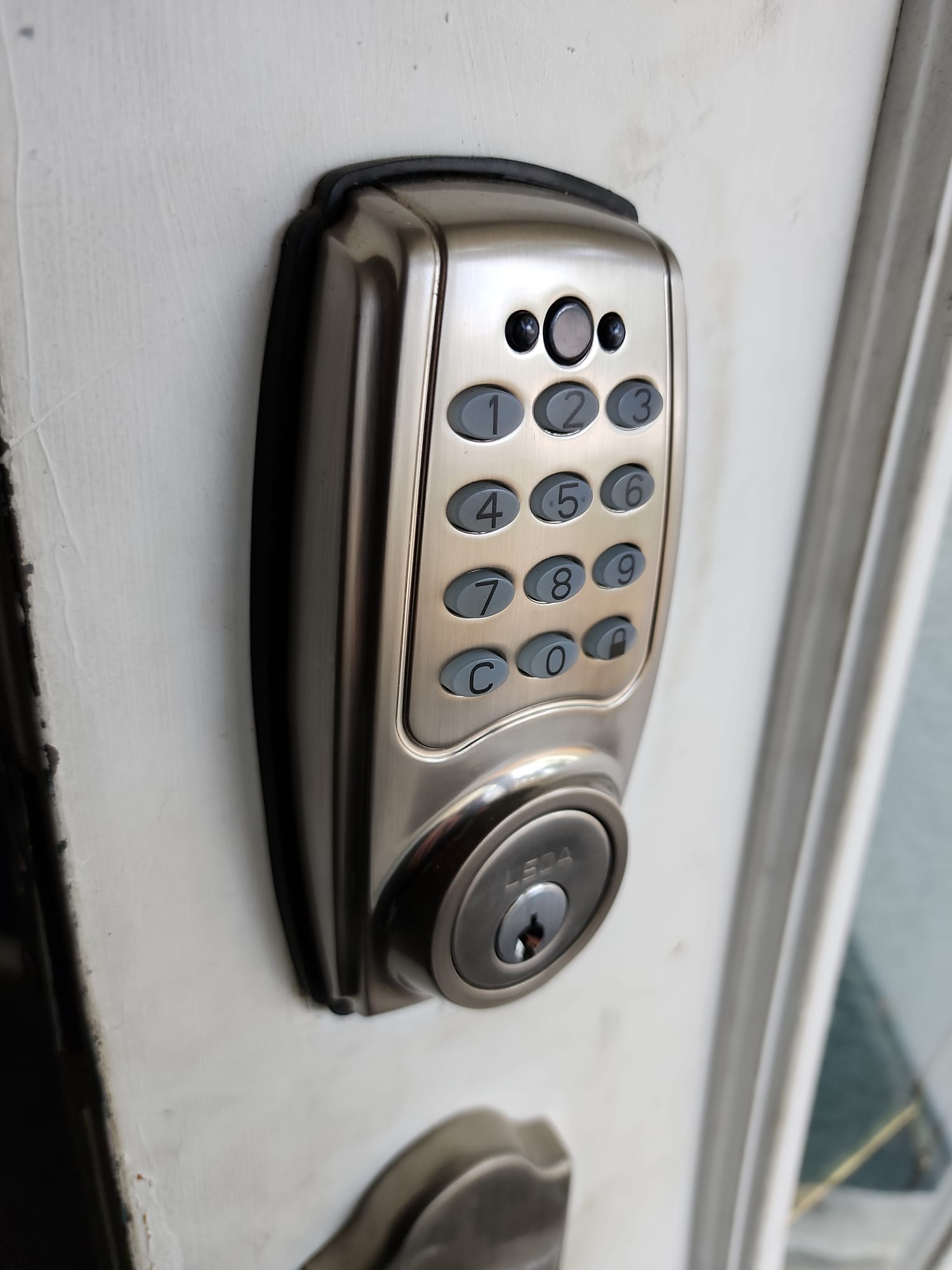 LSDA keypad deadbolt installed on a cream door